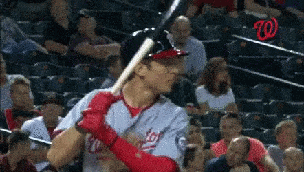 A Baseball Player In A Washington Nationals Uniform Holds His Bat GIF