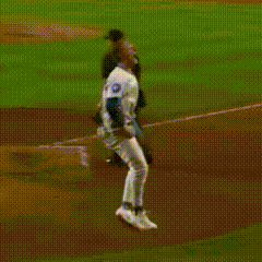A Baseball Player In A White Jersey Is Running On The Field GIF