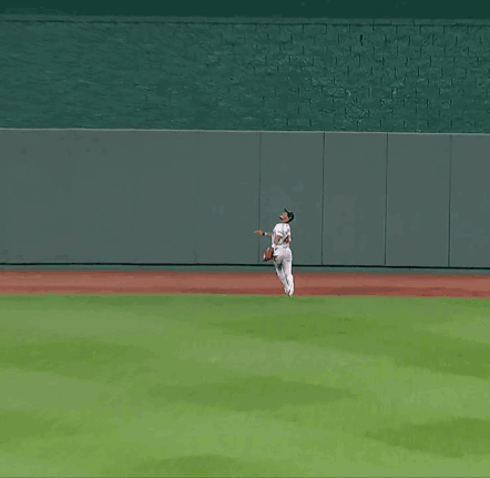 A Baseball Player In A White Uniform Is Running On A Baseball Field GIF