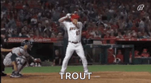 A Baseball Player Is Dancing On The Field During A Game While A Catcher Watches . GIF