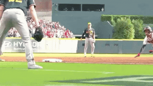 A Baseball Player Is Getting Ready To Throw A Ball While Another Player Watches . GIF