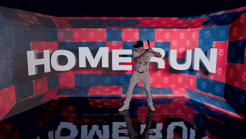 A Baseball Player Is Holding A Bat In Front Of A Wall That Says Home Run GIF
