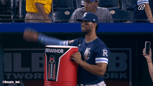 A Baseball Player Is Holding A Bodyarmor Cooler GIF
