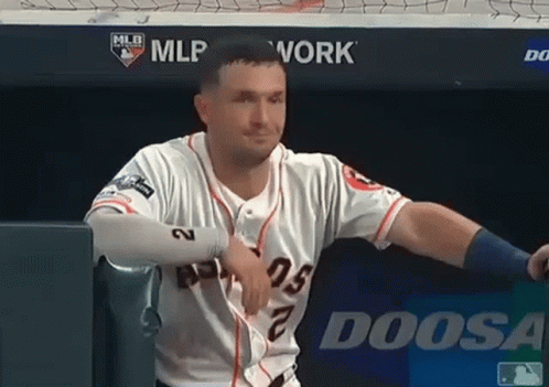 A Baseball Player Is Leaning Against A Wall With A Doosa Logo In The Background GIF