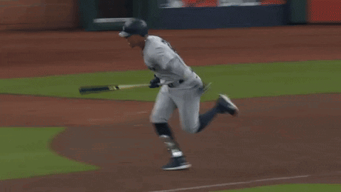 A Baseball Player Is Running On A Field With A Sign That Says ' A ' On It GIF