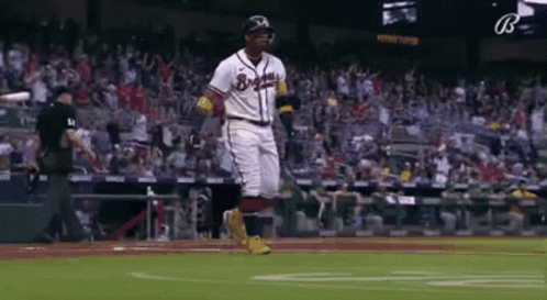 A Baseball Player Is Running On The Field During A Baseball Game . GIF