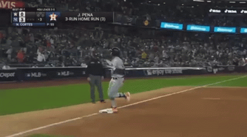 A Baseball Player Is Running To The Base During A Game . GIF