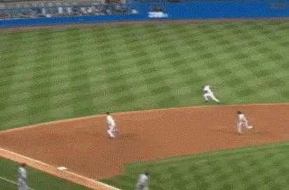 A Baseball Player Is Running Towards Home Plate While A Crowd Of People Watch . GIF