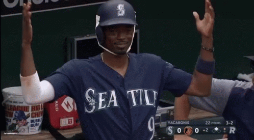 A Baseball Player Is Sitting In The Dugout With A Bank Of America Banner Behind Him GIF