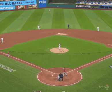 a baseball player is sliding into home plate while a referee looks on