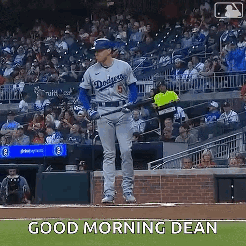 a baseball player is standing on a baseball field with a bat in his hand .