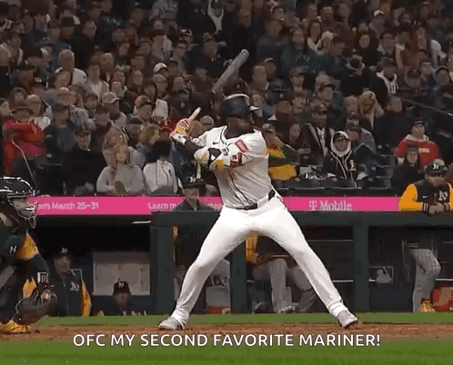 A Baseball Player Is Swinging A Bat At A Ball And Says Ofc My Second Favorite Mariner GIF