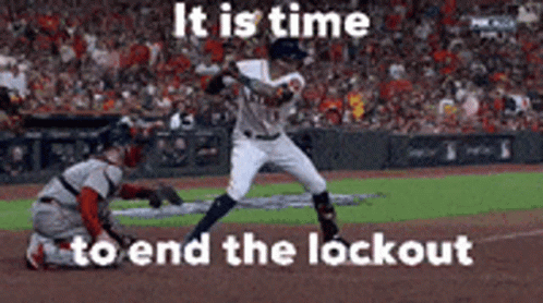 A Baseball Player Is Swinging A Bat At A Ball While A Catcher Looks On . GIF