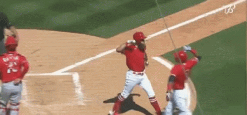 A Baseball Player Is Swinging A Bat At A Ball While A Catcher Watches . GIF