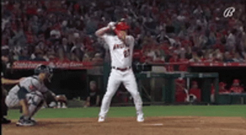 A Baseball Player Is Swinging A Bat At A Ball While A Catcher Watches . GIF