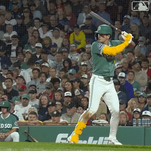 A Baseball Player Is Swinging A Bat In Front Of A Crowd With The Letter B On His Jersey GIF