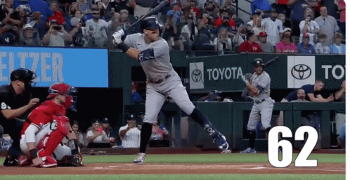A Baseball Player Is Swinging At A Ball With The Number 62 On The Bottom Right GIF