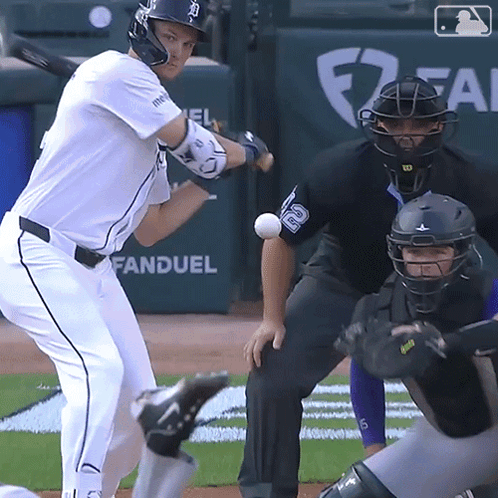A Baseball Player Is Swinging At A Ball With The Word Fan Duel Behind Him GIF
