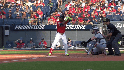 A Baseball Player Is Swinging At A Pitch In Front Of A Progressive Banner GIF