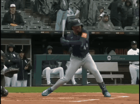 A Baseball Player Is Swinging At A Pitch In Front Of A Wall That Says Milwaukee Astros GIF