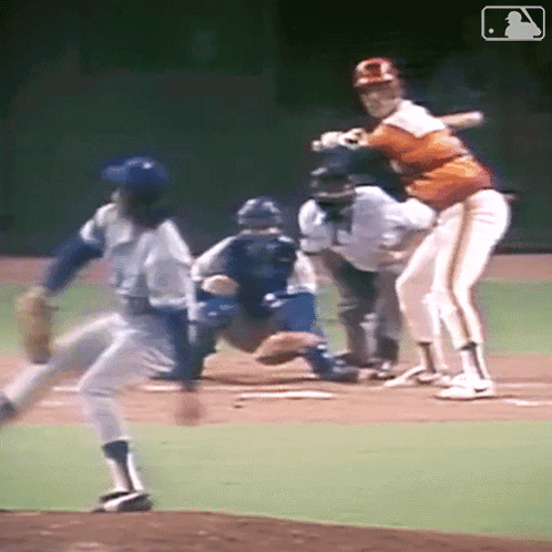 A Baseball Player Is Swinging His Bat At A Ball GIF