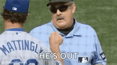 A Baseball Player Is Talking To A Referee On A Baseball Field . GIF