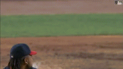 a baseball player is trying to catch the ball while a catcher is kneeling down