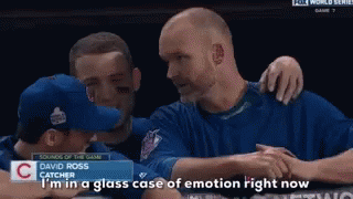 A Baseball Player Named David Ross Is Hugging Another Player GIF