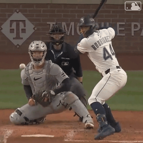 A Baseball Player Named Rodriguez Is Swinging At A Ball GIF