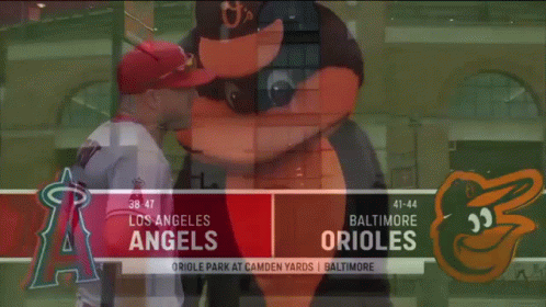 A Baseball Player Standing Next To A Mascot On A Baseball Field . GIF