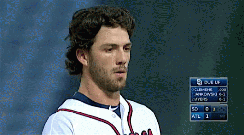 A Baseball Player Stands In Front Of A Scoreboard That Says Due Up On It GIF