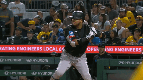 A Baseball Player Stands In Front Of A Sign That Says Rating Engineers GIF
