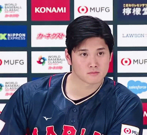 A Baseball Player Stands In Front Of A Wall That Has Konami And Mufg Logos On It GIF