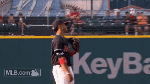 A Baseball Player Stands On A Field With A Key Bank Logo In The Background GIF