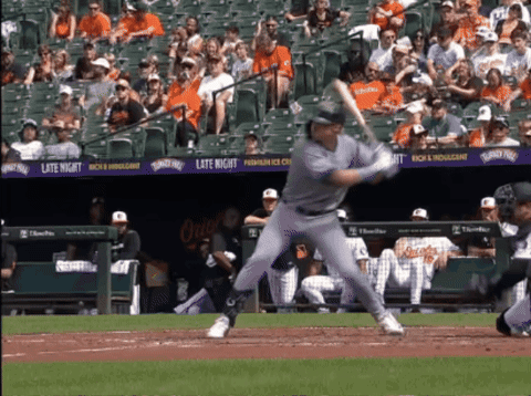 A Baseball Player Swings At A Pitch In Front Of A Banner That Says Late Night On It GIF