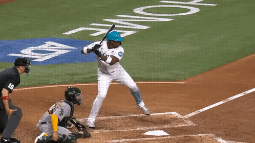 A Baseball Player Swings His Bat At A Pitch In Front Of A Home Plate GIF