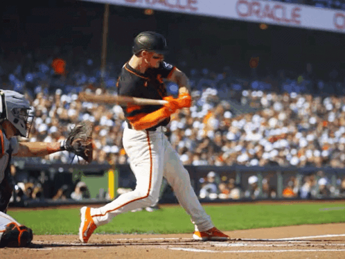 A Baseball Player Swings His Bat At A Pitch In Front Of An Oracle Banner GIF