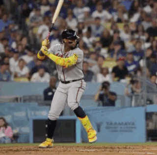 A Baseball Player Swings His Bat At A Pitch GIF