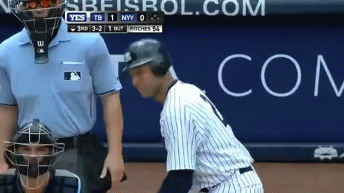 A Baseball Player Talking To A Referee In Front Of A Com Advertisement GIF