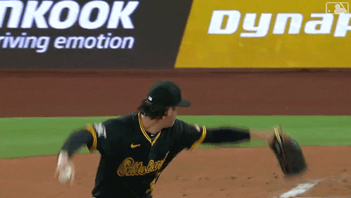 A Baseball Player Throws A Ball In Front Of An Advertisement For Dynair GIF