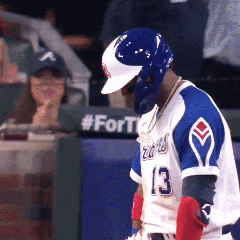 A Baseball Player Wearing A Blue And White Jersey With The Number 13 On It GIF