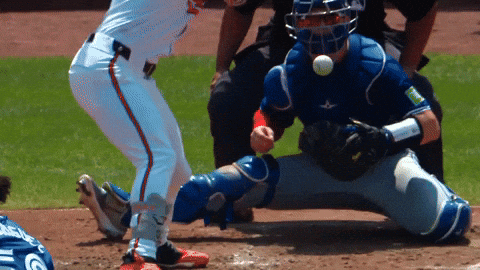 A Baseball Player Wearing A Blue Catcher 'S Helmet Is Getting Ready To Catch The Ball GIF