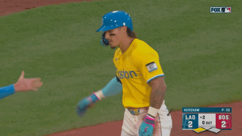 A Baseball Player Wearing A Blue Helmet And A Yellow Jersey With The Word Posto On It GIF