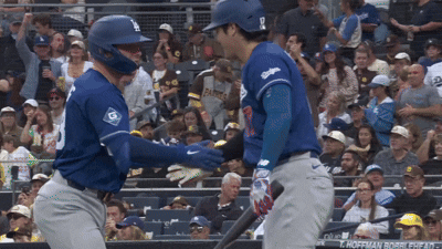 A Baseball Player Wearing A Blue Jersey With The Number 9 On It GIF