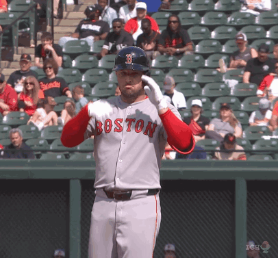 A Baseball Player Wearing A Boston Jersey Holds His Helmet Up GIF