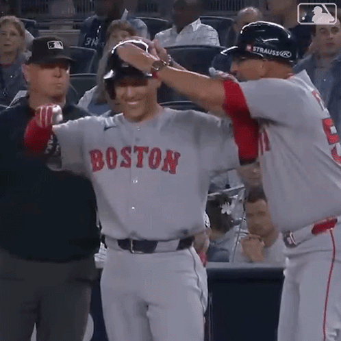 A Baseball Player Wearing A Boston Jersey Is Being Congratulated By Another Player GIF