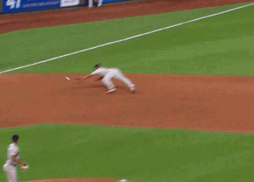 A Baseball Player Wearing A Boston Jersey Is Kneeling Down To Catch A Ball GIF
