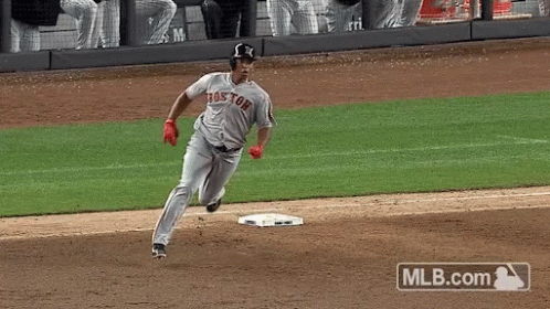 A Baseball Player Wearing A Boston Jersey Is Running To Base GIF