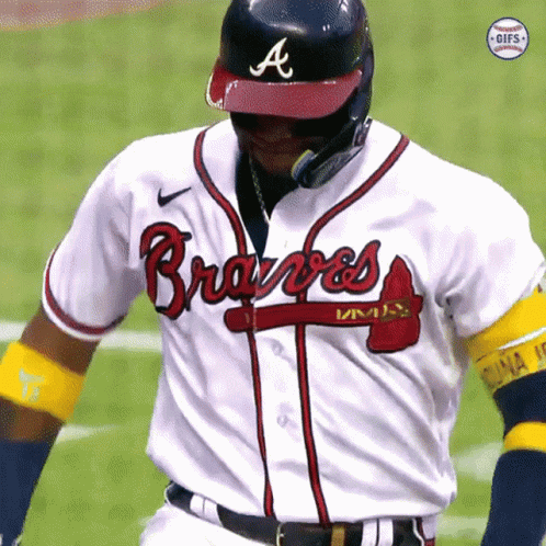 A Baseball Player Wearing A Braves Jersey And A Helmet GIF