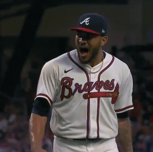 A Baseball Player Wearing A Braves Jersey And Hat GIF